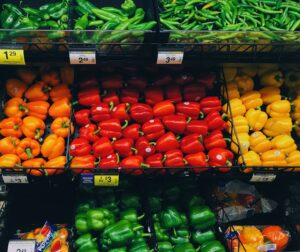 pile of bell peppers and beans at the grocery