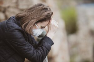 woman in black leather jacket wearing white framed eyeglasses covering her face