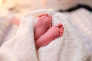 baby covered with white blanket