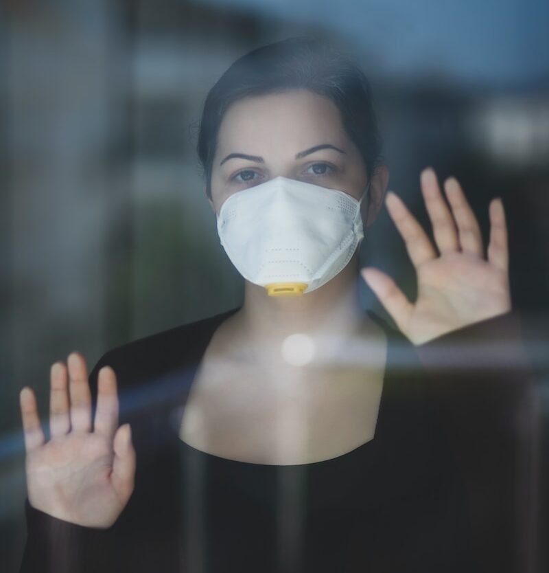 person covering face with white mask