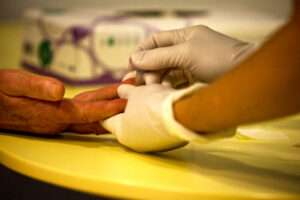 Close up photo of gloved hands conducting a blood test