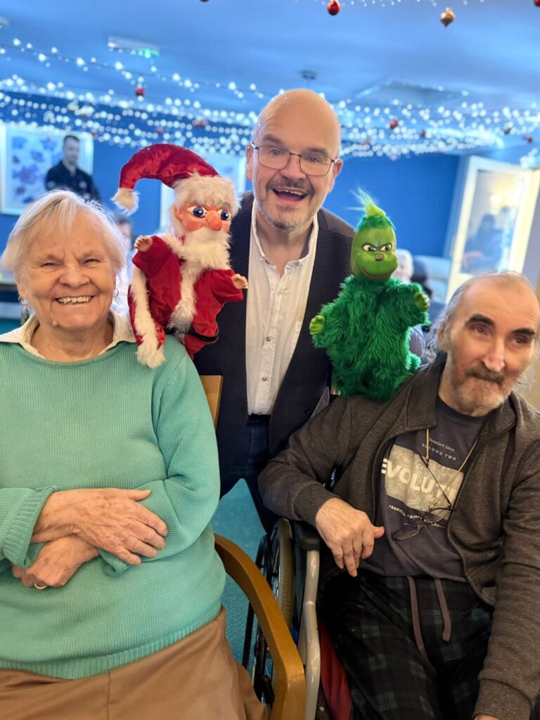 Professor Paul Wheeler and his puppets with two residents of Catherine House Care Home in Frome