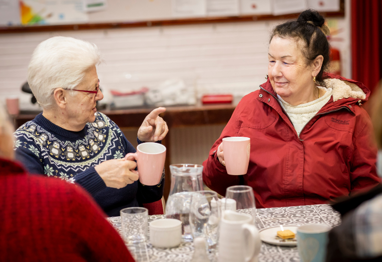 Two people sharing tea at a Warm Walsall coffee morning, photo courtesy of Walsall Council