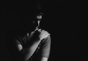 man holding his left shoulder