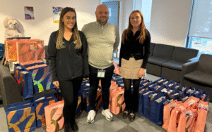 Georgia Fogarty, LCRIG with Ben Hughes and Aimee Dewse from Multevo, and gifts bags ready to go to care leavers; photo courtesy of Blackburn with Darwen Council.