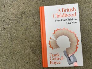 Photo of the book A British Children - How Our Children Live Now by Frank Cottrell Boyce, with image showing a pencil shaving making up the outline of a child's head